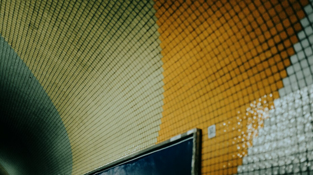 Laptop screen showing colorful lines of programming code