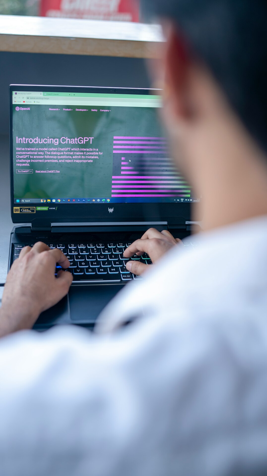 young person coding on laptop